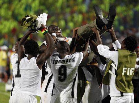 Ghana's coach Sellas Tetteh is lifted in the air by his players as they celebrate their win over Brazil during their FIFA U-20 World Cup final soccer match in Cairo, October 16, 2009. PHOTO BY REUTERS/Marko Djurica