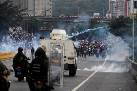 Police fire tear gas toward opposition supporters during clashes while rallying against Venezuela's President Nicolas Maduro in Caracas, Venezuela. PHOTO BY REUTERS/Carlos Garcia Rawlins