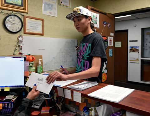 Terrell Elk, 18, votes for the first time by delivering his absentee ballot for the 2018 mid-term election to the Sioux County Auditor's office on the Standing Rock Reservation in Fort Yates, North Dakota, U.S., October 26, 2018. PHOTO BY REUTERS/Dan Koeck