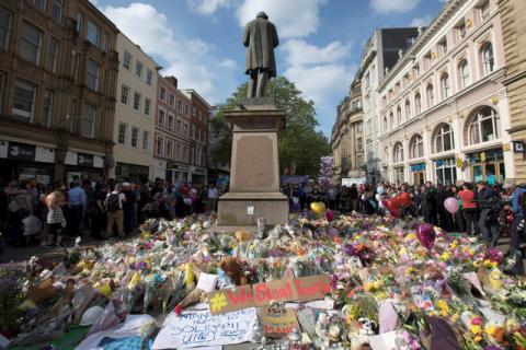 Messages and floral tributes left for the victims of the attack on Manchester Arena lie around the statue in St Ann's Square in central Manchester, May 24, 2017. PHOTO BY REUTERS/Jon Super