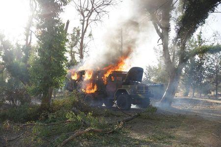 A military truck belonging to Syrian president Bashar Al-Assad forces is seen on fire at the military Brigade 52 base after it was captured by the Free Syrian Army in Daraa, Syria, June 9, 2015. PHOTO BY REUTERS/Alaa Al-Faqir