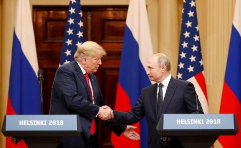 U.S. President Donald Trump and Russian President Vladimir Putin shake hands as they hold a joint news conference after their meeting in Helsinki, Finland, July 16, 2018. PHOTO BY REUTERS/Grigory Dukor