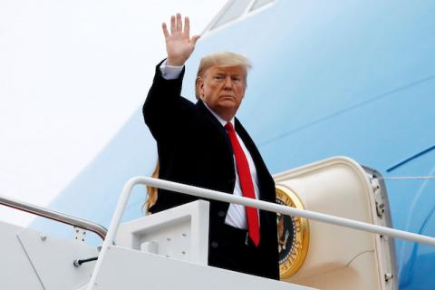 U.S. President Donald Trump waves as he boards Air Force One with First Lady Melania Trump at Joint Base Andrews in Maryland en route to West Palm Beach, Florida, U.S., on January 31, 2020. PHOTO BY REUTERS/Yuri Gripas