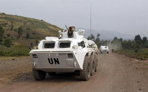 U.N. peacekeepers drive in their armoured personnel carrier (APC) as they patrol the road towards Kibati, outside Goma