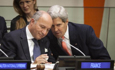U.S. Secretary of State John Kerry (R) speaks to France's Foreign Minister Laurent Fabius during an administrial meeting of the Group of Friends of the Syrian People