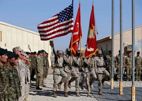 U.S. Marines march with flags during a handover ceremony, as the last U.S. Marines unit and British combat troops end their Afghan operations, in Helmand, October 26, 2014. PHOTO BY REUTERS/Omar Sobhani