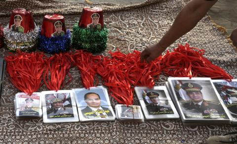 A street vendor sells memorabilia of former Egyptian army chief Abdel Fattah al-Sisi after his victory in presidential vote at Tahrir square in Cairo