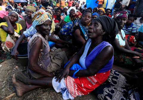 Women wait to receive aid at a camp for the people displaced in the aftermath of Cyclone Idai in John Segredo near Beira, Mozambique, March 31, 2019. PHOTO BY REUTERS/Zohra Bensemra