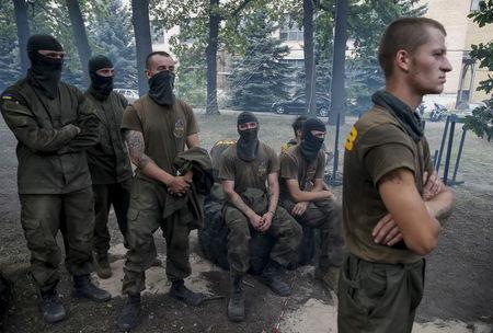 New volunteers for the Ukrainian interior ministry's "Azov" battalion look on as they take part in tests before heading to frontlines in eastern Ukraine, at the battalion's training centre in Kiev, Ukraine, August 14, 2015. PHOTO BY REUTERS/Gleb Garanich