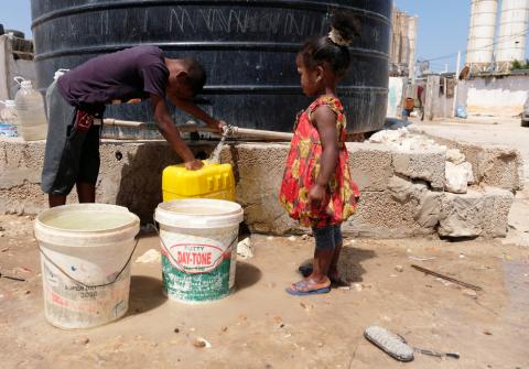 Libyan children displaced from the town of Tawergha fill containers with water at a displaced camp in Benghazi, Libya, June 19, 2019. PHOTO BY REUTERS/Esam Omran Al-Fetori