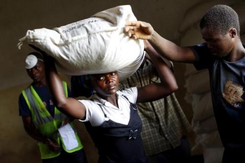 A woman carries food aid distributed by the United Nations World Food Progamme (WFP) in Mzumazi village near Malawi's capital Lilongwe, February 3, 2016. PHOTO BY REUTERS/Mike Hutchings