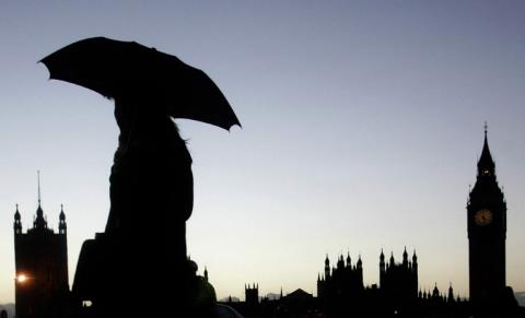 A woman holds her umbrella as she walks across Westminster Bridge in front of Big Ben in London January 11, 2007. One man was killed as gale force winds and heavy rain caused severe disruption across parts of the country on Thursday, knocking down power lines and closing roads. PHOTO BY REUTERS/Luke MacGregor (BRITAIN)