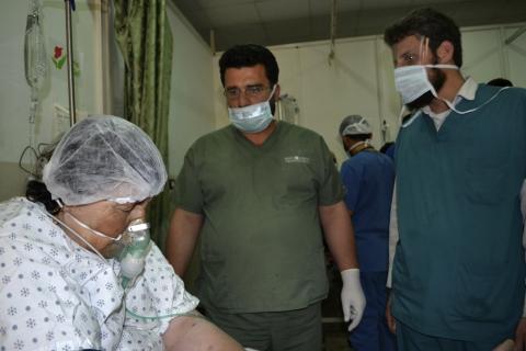 A woman affected by what activists say was a gas attack on the town of Telminnes breathes through an oxygen mask at Bab al-Hawa hospital, where she was transferred to, close to the Turkish border
