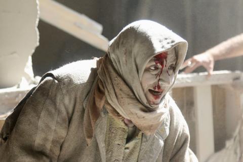 An injured woman reacts at a site hit by airstrikes in the rebel held area of Old Aleppo, Syria, April 28, 2016. PHOTO BY REUTERS/Abdalrhman Ismail