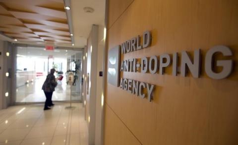 A woman walks into the head office for the World Anti-Doping Agency (WADA) in Montreal, November 9, 2015. PHOTO BY REUTERS/Christinne Muschi