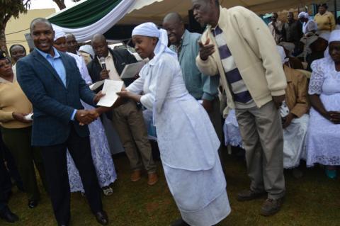 A Shona woman is presented with a birth certificate at Kinoo near Nairobi, Kenya, August 1, 2019. PHOTO BY Thomson Reuters Foundation/Maina Waruru
