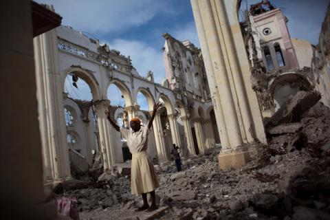 A woman prays among the rubble of the damaged main cathedral in downtown Port-au-Prince, January 9, 2011. PHOTO BY REUTERS/Allison Shelley