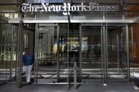 A woman exits the New York Times Building in New York