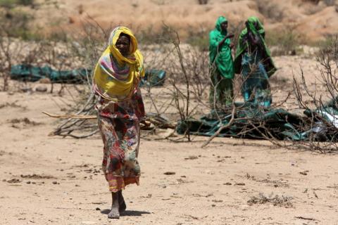 An internally displaced woman walks through a camp on the outskirts of the town of Qol Ujeed, on the border with Ethiopia, Somaliland, April 17, 2016. PHOTO BY REUTERS/Siegfried Modola
