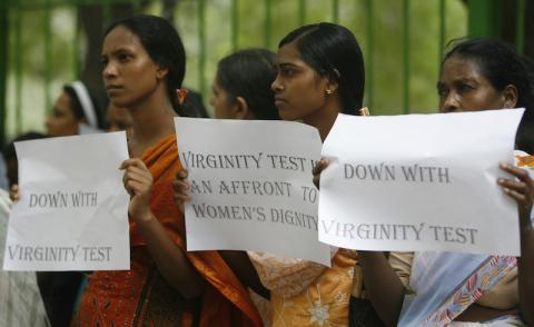 Women protesters hold placards during a protest in New Delhi July 29, 2009. The National Federation of Indian Women said women organisations in the country demonstrated on Wednesday against virginity tests in India's Madhya Pradesh and Kerala states. The organisation also said, 151 young women were subjected to virginity tests by the administration in Madhya Pradesh during a state-sponsored mass marriage last month. PHOTO BY REUTERS/Fayaz Kabli 