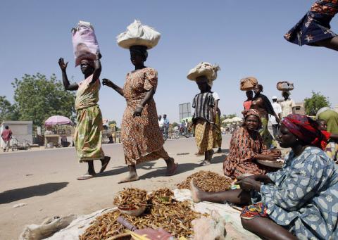 Chadian women walk past fried locust sellers at a market in Chgoua in N'Djamena, November 17, 2007. PHOTO BY REUTERS/Luc Gnago