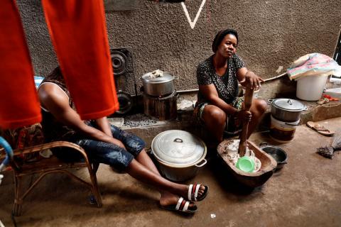 Honrne Waba, 40, who has fled the northwestern village of Njinikom because of violence, cooks as her son-in-law sits in the courtyard of the house where she is staying in Yaounde, Cameroon, October 3, 2018. PHOTO BY REUTERS/Zohra Bensemra