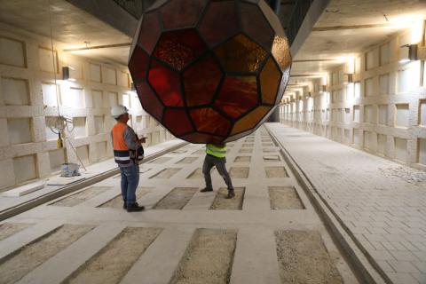 Labourers work with a large light fixture as they continue construction on a new underground cemetery, located at Givat Shaul Cemetery in Jerusalem, October 6, 2019. PHOTO BY REUTERS/Ammar Awad