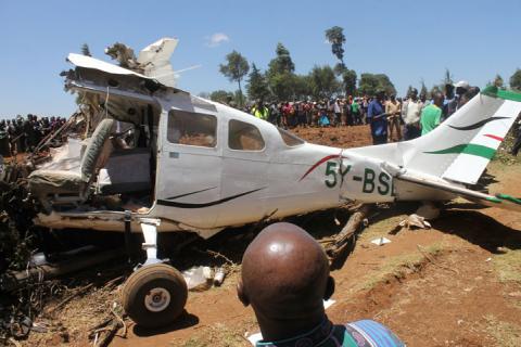 Rescuers and bystanders gather near the wreckage of a Cessna 206 light aircraft that crashed with its Kenyan pilot and four foreign passengers at an agricultural farm in Londiani, Kericho county, Kenya, February 13, 2019. PHOTO BY REUTERS/Stringer