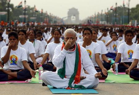 India's Prime Minister Narendra Modi performs yoga with others during a yoga camp to mark the International Day of Yoga, in New Delhi, India, June 21, 2015. PHOTO BY REUTERS/Adnan Abidi