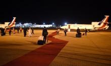 Employees arrange the red carpet prior the departure of the planes of the French delegation at the airport in Abuja, Nigeria, May 14, 2016. PHOTO BY REUTERS/Stephane De Sakutin