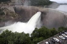 People watch as the spillway gates are opened at Kariba North Bank dam on Lake Kariba in a file photo. PHOTO BY REUTERS/Mackson Wasamunu