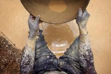 Artisanal gold miner Mamadou Diarra pans for gold at a small scale mine in Kalana. PHOTO BY REUTERS/Joe Penney