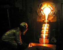 Gold Fields' big mine in Obuasi, Ghana, supervises the pouring of gold heated to around 1,600 centigrade. PHOTO BY REUTERS