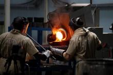 Employees pour liquid gold into a mould for the production of an ingot during the refining process at AGR (African Gold Refinery) in Entebbe, Uganda. PHOTO BY REUTERS/Baz Ratner