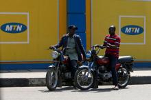 Men sit on motorbikes past advertising posters for MTN telecommunication company along a street in Lagos, Nigeria, October 30, 2018. PHOTO BY REUTERS/Afolabi Sotunde