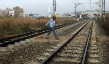 A man walks across a railway line in Orlando, Soweto, May 17, 2010. PHOTO BY REUTERS/Stringer