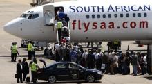 Passengers board a South African Airways Boeing 737 aircraft at the Kamuzu International Airport in Lilongwe. PHOTO BY REUTERS/Siphiwe Sibeko