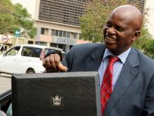 Minister of Finance Patrick Chinamasa carries the briefcase containing the 2017 National Budget at the Parliament in Harare, Zimbabwe, December 8, 2016. PHOTO BY REUTERS/Philimon Bulawayo
