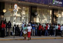 Zimbabweans queue outside a branch of First Capital Bank in Harare, Zimbabwe, February 23, 2019. PHOTO BY REUTERS/Philimon Bulawayo