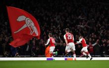 Arsenal's Alexandre Lacazette celebrates scoring their first goal with team mates. PHOTO BY REUTERS/Dylan Martinez