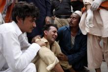 A man cries over the death of his brother, who was killed in a bomb blast, at a hospital in Peshawar