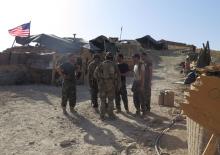 U.S. and Afghan National Army (ANA) soldiers chat with each other at a post in Deh Bala district, Nangarhar province, Afghanistan, July 7, 2018. PHOTO BY REUTERS/James Mackenzie