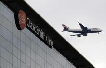 A British Airways airplane flies past a signage for pharmaceutical giant GlaxoSmithKline (GSK) in London April 22, 2014. PHOTO BY REUTERS/Luke MacGregor