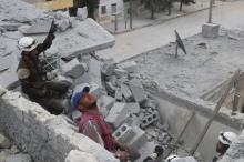 Civil defense members work at a site hit by an airstrike in the rebel held area of Aleppo's Baedeen district, Syria, May 3, 2016. PHOTO BY REUTERS/Abdalrhman Ismail
