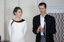 Syria's President Bashar al-Assad stands next to his wife Asma, as he addresses injured soldiers and their mothers during a celebration marking Syrian Mother's Day in Damascus, in this handout picture provided by SANA, March 21, 2016. PHOTO BY REUTERS/SANA