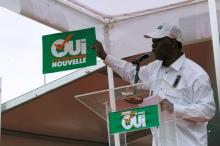 Ivory Coast's President Alassane Ouattara holds a placard as he speaks during a rally, ahead of the referendum of a new constitution, in Abidjan, October 22, 2016.The placard reads "yes to new Ivory Coast". PHOTO BY REUTER/Luc Gnago