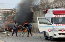 Somali rescue workers carry an unidentified man injured from the scene of an explosion in Mogadishu, Somalia, November 9, 2018. PHOTO BY REUTERS/Feisal Omar