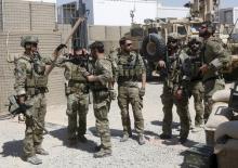 U.S. special forces soldiers talk to each other before they leave their base in Helmand, Afghanistan, September 28, 2015. PHOTO BY REUTERS/Omar Sobhani