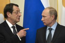 Cyprus President Nicos Anastasiades (L) speaks to Russian President Vladimir Putin during their meeting at the Novo-Ogaryovo state residence outside Moscow, February 25, 2015. PHOTO BY REUTERS/Yuri Kadobnov
