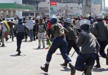 Anti-riot police chase after protesters during a march against President Robert Mugabe's government's handling of the economy in Harare, Zimbabwe, August 3, 2016. PHOTO BY REUTERS/Philimon Bulawayo